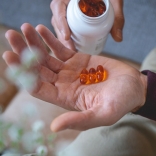 pharmanex-marine-omega-softgels-in-hand-lifestyle-aerial-image.jpg